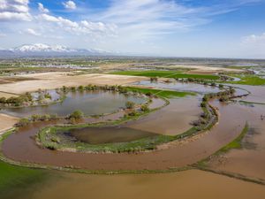 (Francisco Kjolseth | The Salt Lake Tribune) High water flow jumps the snaking banks of the Weber River near Farmington Bay, flooding adjacent farmland on Tuesday, May 2, 2023. 