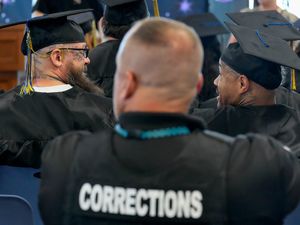 (Francisco Kjolseth | The Salt Lake Tribune) Prison inmates Dusten Anderson, left, and Albert Givens get ready to receive their high school diplomas as the Utah Department of Corrections and Salt Lake City School District host the inaugural high school graduation ceremony at the Utah State Correctional Facility on Monday, June 5, 2023.