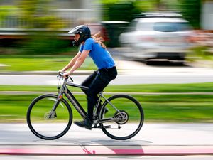 (Francisco Kjolseth | The Salt Lake Tribune) A cyclist pedals though Liberty Park in Salt Lake City on an e-bike on Monday, May 22, 2023. 