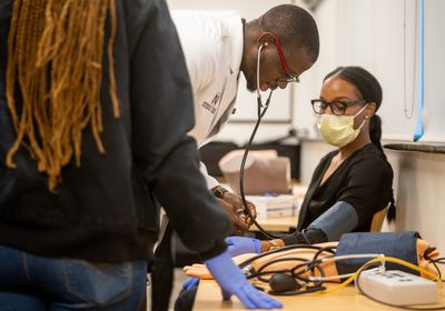 (Trent Nelson  |  The Salt Lake Tribune) Medical student Jude Emego demonstrates taking blood pressure at Alta View Hospital in Sandy on Saturday, Sept. 24, 2022. The Tribune is seeking responses on wait times to secure an appointment with a medical professional.